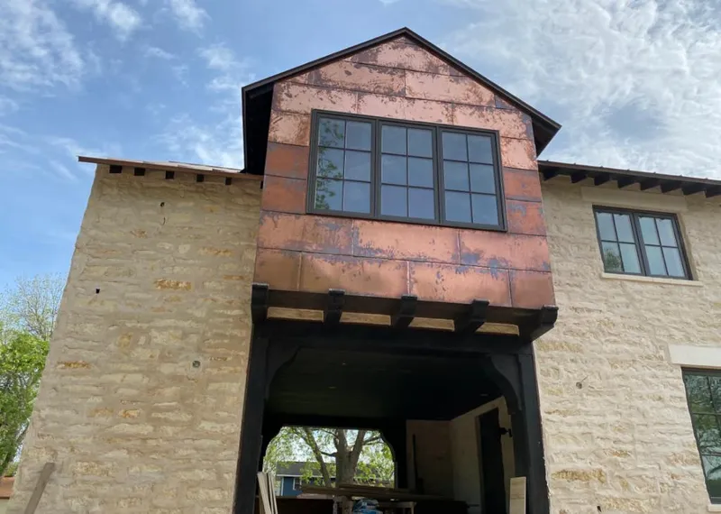 Copper metal panel facade on a stone building for Skylight Installation in Surfside