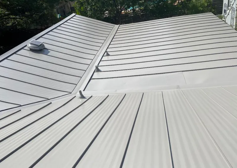 Solar attic fan installed on a metal roof for Roof Ventilation in Surfside